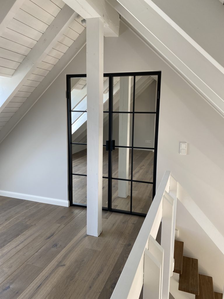 Lofttür mit Spiegelglas im Dachgeschoss als Ankleidezimmer