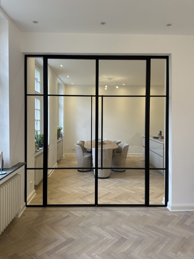 Große Doppelflügel Lofttür aus schwarzem Stahl mit grauem Glas als Raumteiler im Büro